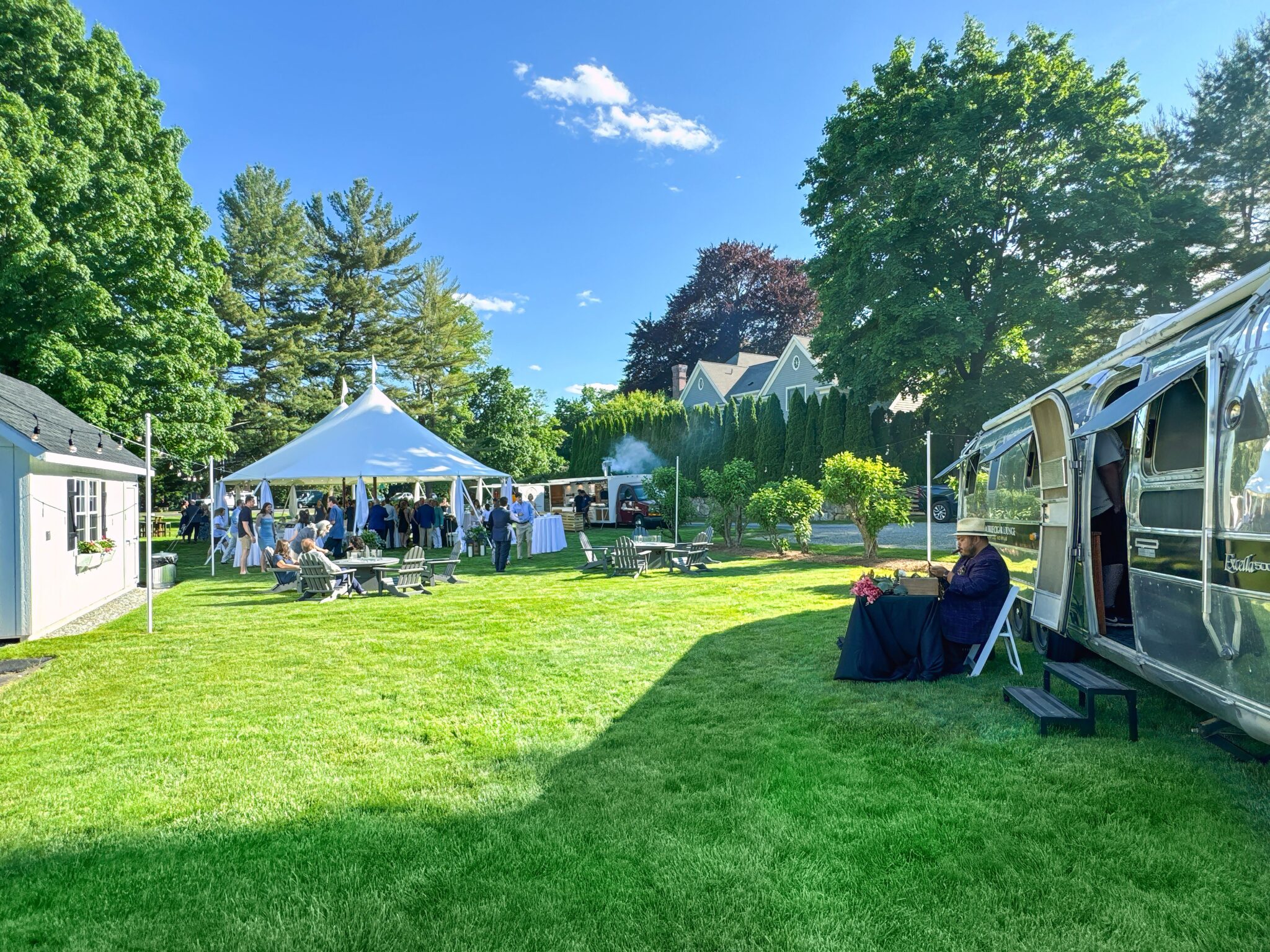Outdoor event on West Lane Inn grounds with tent and guests