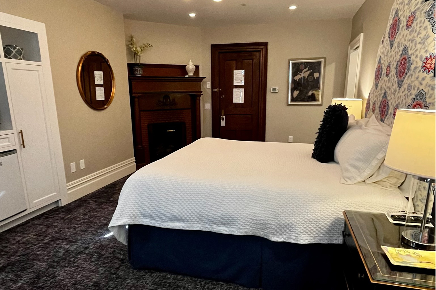 Room 105 — Signature King room with king bed and fireplace mantel