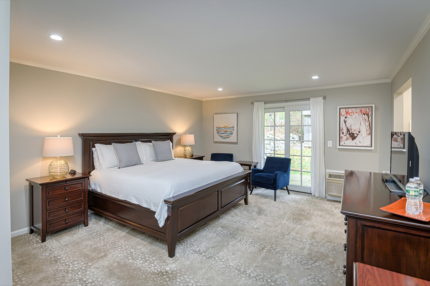 Room 401 — Cottage King Suite with king bed, dark wood furniture, and garden views